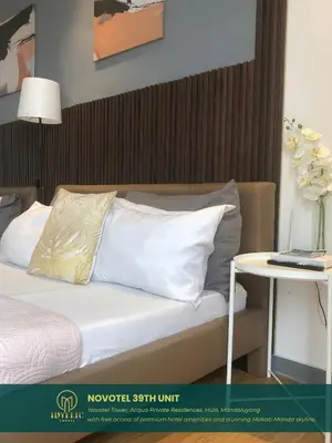 a bed with white pillows and a table with a lamp at Novotel Twin Bed at Mandaluyong Near Makati FREE pool in Manila