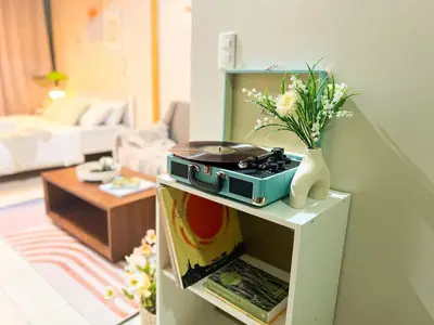 a living room with a vase of flowers on a table at Premium BGC 1BR Condo Near Grand Hyatt #oursw9d1 in Manila