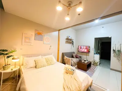 a bedroom with a bed and a living room at Premium BGC 1BR Condo Near Grand Hyatt #oursw9d1 in Manila