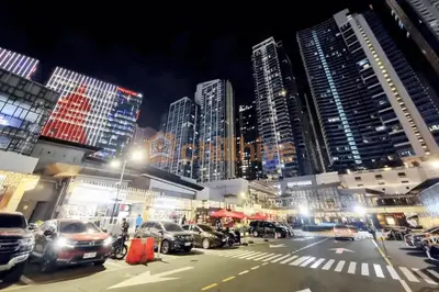 a city street with cars parked in front of tall buildings at Premium BGC 1BR Condo Near Grand Hyatt #oursw9d1 in Manila