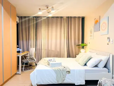 a bedroom with a large white bed and a desk at Premium BGC 1BR Condo Near Grand Hyatt #oursw9d1 in Manila