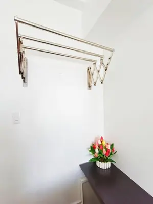 a room with a table with a vase of flowers at University Belt Cozy Studio at Vista Recto-33rd Floor in Manila