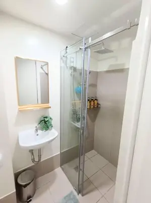 a bathroom with a shower and a sink at University Belt Cozy Studio at Vista Recto-33rd Floor in Manila