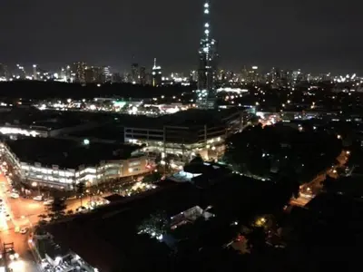 a view of a city at night with lights at Greenhills 1BR Lower Penthouse w Panoramic View in Manila