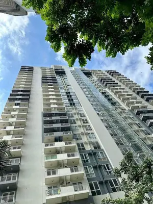 a tall white apartment building with balconies on it at Chill Spot Staycation in Pasig in Manila