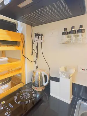 a kitchen with a counter top with a stove at Zenrise Staycation in Trece Martires