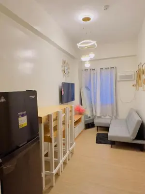 a kitchen and dining room with a table and chairs at Zenrise Staycation in Trece Martires
