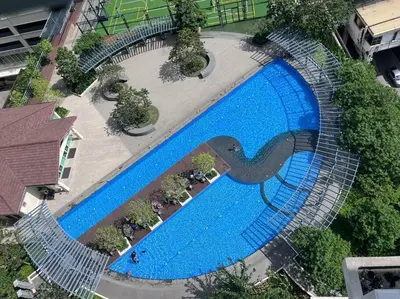 an overhead view of a large blue swimming pool at Spacious 2BR Condo San Lorenzo Place 4KM Airport in Manila