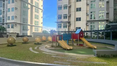 a playground in front of some tall buildings at Spacious 2BR Condo San Lorenzo Place 4KM Airport in Manila