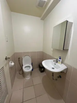 a bathroom with a toilet and a sink at West Bricks in Manila