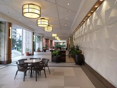 a hallway with tables and chairs in a building at West Bricks in Manila