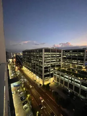 a view of a city street with cars and buildings at Shore Residence Manila Bay City Lights View MOA Complex in Manila