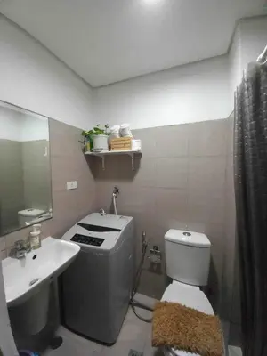 a bathroom with a toilet and a sink at Shore Residence Manila Bay City Lights View MOA Complex in Manila