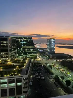 a night view of a city with a parking lot at Shore Residence Manila Bay City Lights View MOA Complex in Manila