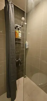 a shower with a glass door in a bathroom at City Life Suite Uptown BGC in Manila