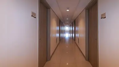 a corridor of a building with a long hallway at SMDC Breeze Residences by RedDoorz in Manila
