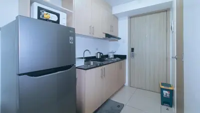 a kitchen with a refrigerator and a sink at SMDC Breeze Residences by RedDoorz in Manila