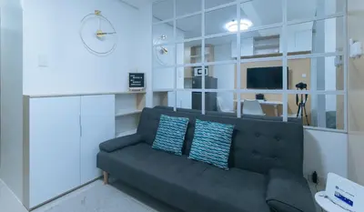 a living room with a gray couch with two pillows at SMDC Breeze Residences by RedDoorz in Manila