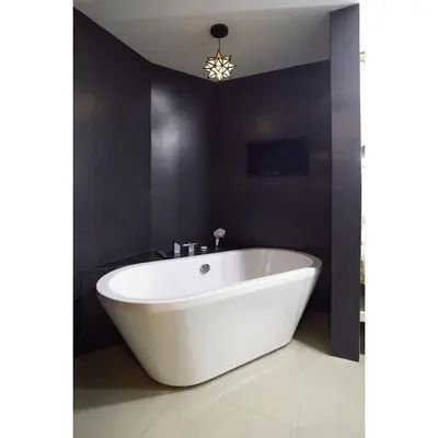 a white bath tub in a bathroom with black walls at Summit Hotel Magnolia in Manila