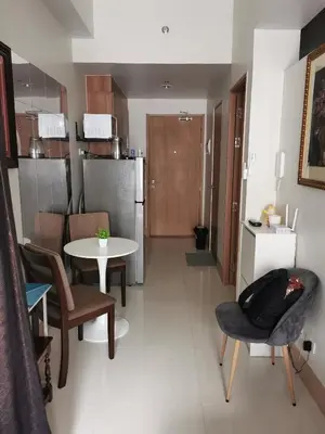 a kitchen and living room with a table and chairs at Mall of Asia Pasay Shore 3 tower 2 Residences in Manila