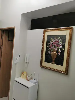a picture of a vase of flowers on a wall at Mall of Asia Pasay Shore 3 tower 2 Residences in Manila