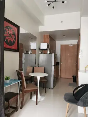 a kitchen and living room with a table and chairs at Mall of Asia Pasay Shore 3 tower 2 Residences in Manila