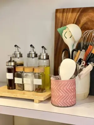 a counter with a shelf with cooking utensils on it at Modern minimalist house in the heart of Antipolo in Antipolo