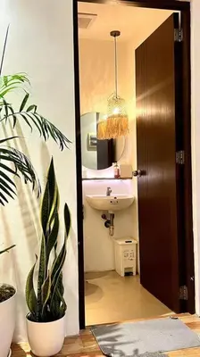 a bathroom with a sink and a mirror and a plant at Tropical hideaway near Antipolo Cathedral in Antipolo