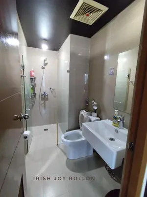 a bathroom with a white toilet and a sink at Condotel Near Naia Terminal 3 in Manila
