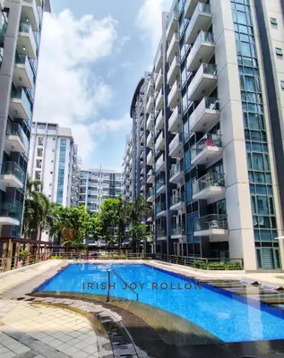 a swimming pool in front of some buildings at Condotel Near Naia Terminal 3 in Manila