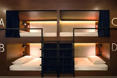 a group of bunk beds in a room at Yamato Hostel in Manila