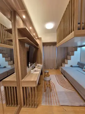 a small room with a bunk bed and a bedroom with a staircase at Nordic Rsquare Manila - with Pool Access in Manila