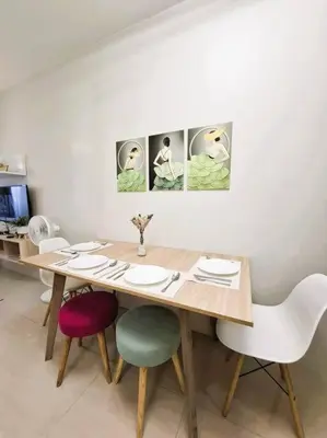 a dining room table with four chairs and a table at Comfy Condo Near NAIA Airport in Manila