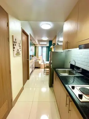 a kitchen with a sink and a counter top at Cozy and aesthetic unit near MOA Airport and IKEA in Manila