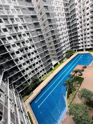 an overhead view of two large apartment buildings with a swimming pool at Cozy and aesthetic unit near MOA Airport and IKEA in Manila