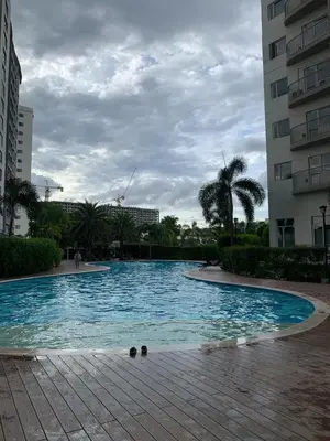 a large swimming pool in a city with buildings at south residences in Manila