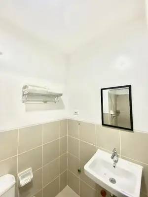a bathroom with a sink and a mirror at south residences in Manila