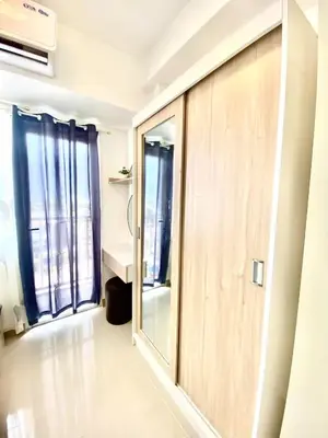 a sliding door in a room with windows at south residences in Manila