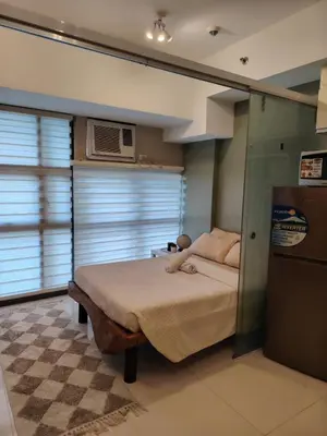a bedroom with a bed with a teddy bear on it at Cozy space in Viceroy Residences McKinley Hill Taguig in Manila