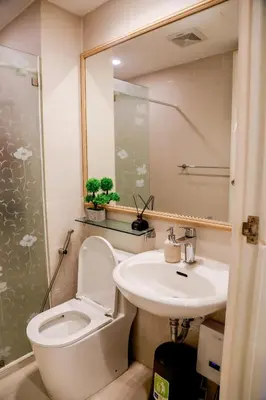 a bathroom with a toilet and a sink at Azure Urban Resort Staycation 1 Bedroom Beach View, 18th floor in Manila