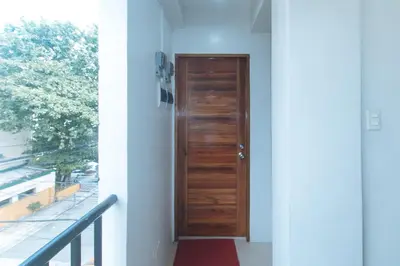 a wooden door on the side of a building at RedDoorz at Delorian Residences in Manila