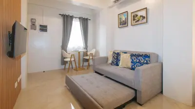 a living room with a couch and a table at RedDoorz at Delorian Residences in Manila