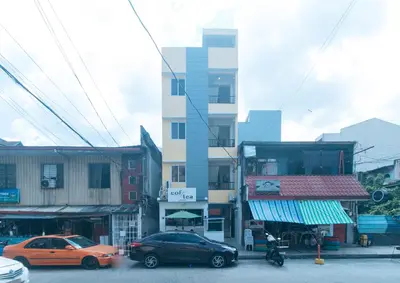 a street with cars parked in front of a building at RedDoorz at Delorian Residences in Manila