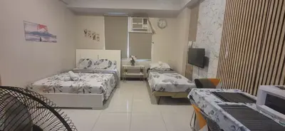 a hospital room with two beds and a television at A&G Condotel at 101newport Right across NAIA T3 in Manila