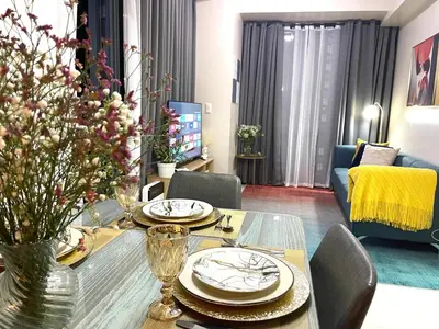 a living room with a dining table and a couch at Executive luxury 2BR Condo Unit in McKinley Hill BGC Taguig in Manila
