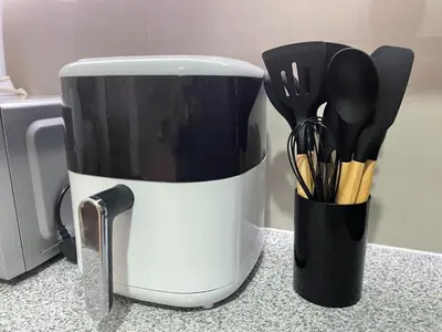 a coffee cup with utensils in it on a counter at Executive luxury 2BR Condo Unit in McKinley Hill BGC Taguig in Manila