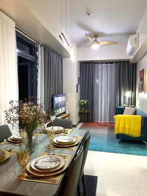 a living room with a dining table and a couch at Executive luxury 2BR Condo Unit in McKinley Hill BGC Taguig in Manila