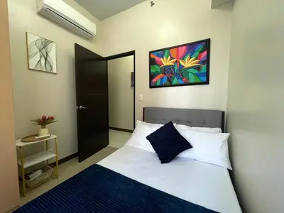 a bedroom with a bed and a painting on the wall at Executive luxury 2BR Condo Unit in McKinley Hill BGC Taguig in Manila
