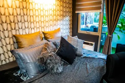 a bed with pillows on it in a room at Azure Urban Resort Staycation 1Bedroom with PS4, 3rd floor in Manila