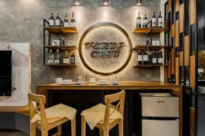 a bar with two chairs and a mirror on the wall at 1BR Makati, Lush Residences M004 in Manila